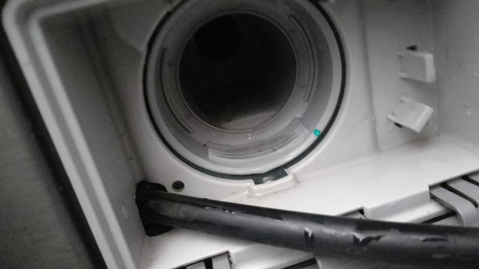 Inside an open LG washing machine during a repair call-out in Midrand