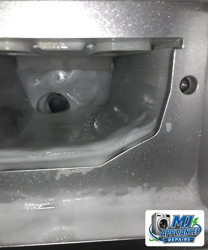 Foam pushed up into the detergent drawer housing of a front loader washing machine